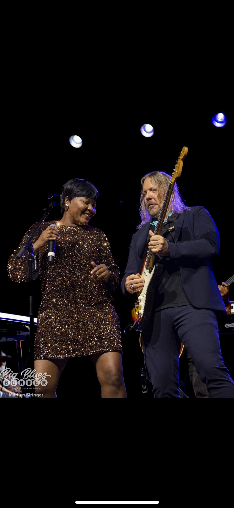 Sierra Green performing onstage with a guitarist