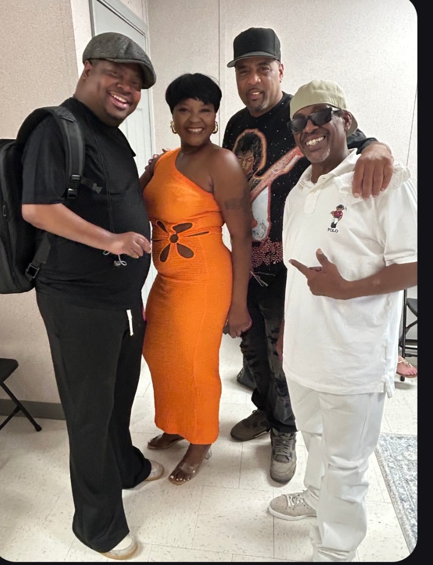 Sierra Green smiling with fellow musicians backstage